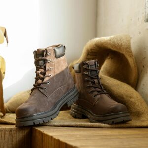 Stylish brown leather boots displayed on a rustic wooden surface with burlap backdrop.